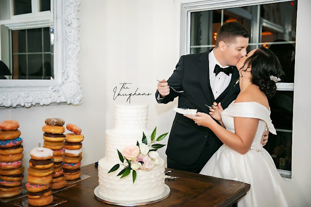 bride and groom kissing during cake cutting