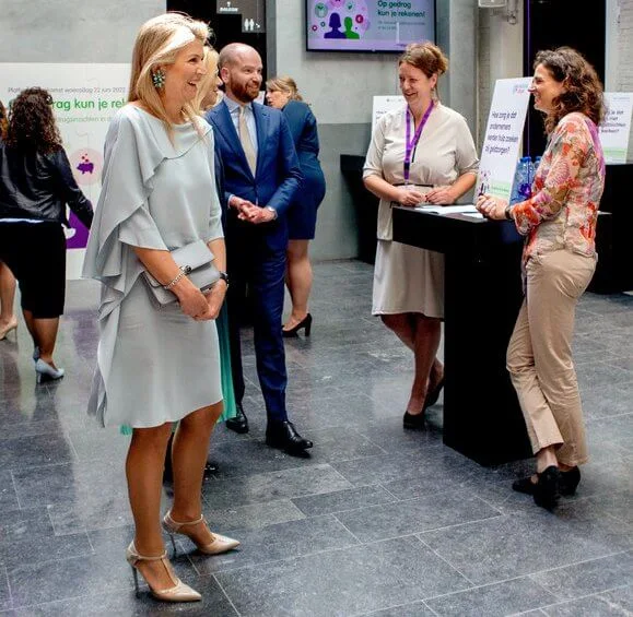 Queen Maxima wore a sky blue silk dress by Natan, blue floral earrings, Gianvito Rossi pumps