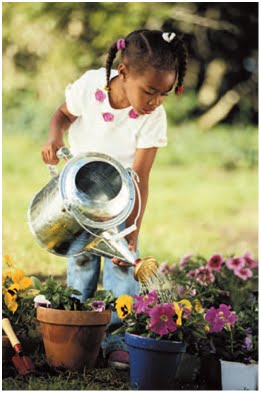 NAMC montessori preschool student introducing gardening girl watering plants