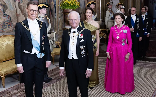 Queen Silvia wore a Padme pink gown by Georg et Arend. Princess Victoria wore a feather cape gown by Toteme