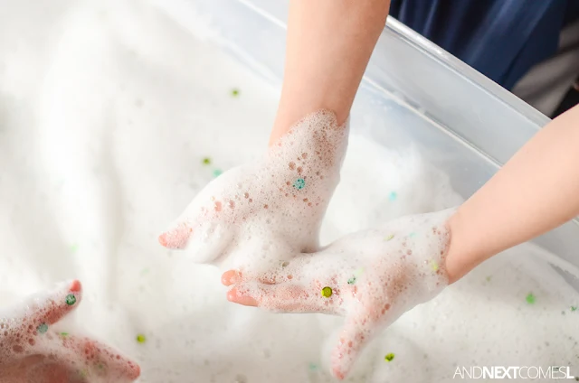 Easy sensory bin idea for kids: sparkle soap foam from And Next Comes L