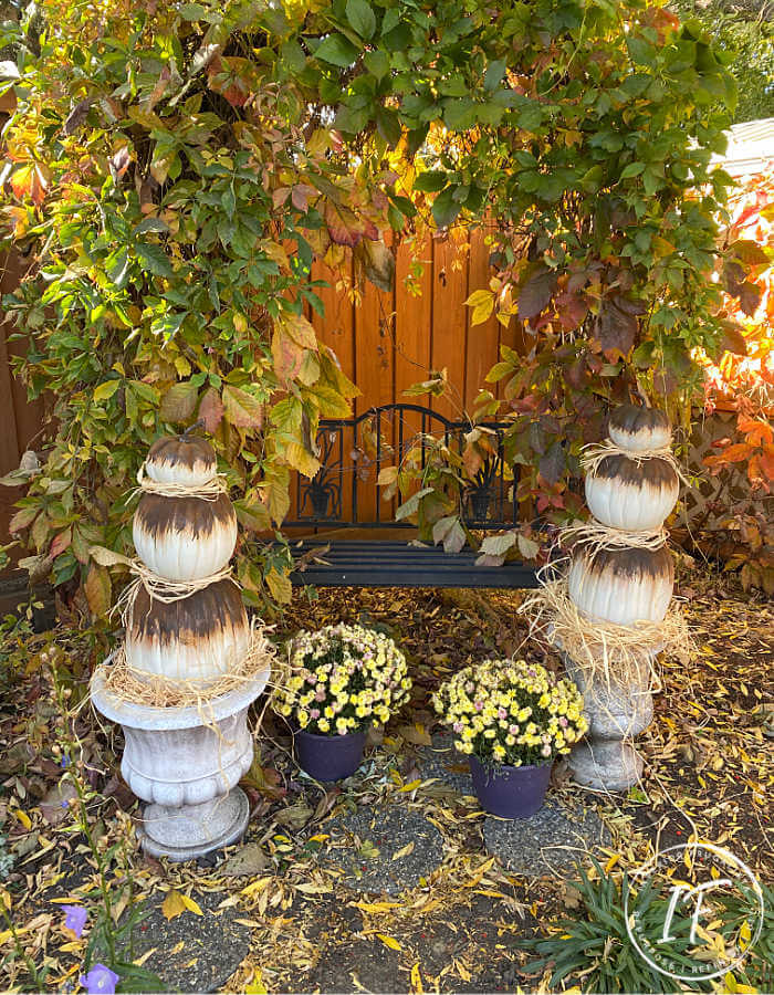Unique Rust Paint Dripped Abstract Pumpkin Topiaries with white artificial stacked pumpkins and rust activated paint to decorate outdoors for fall.