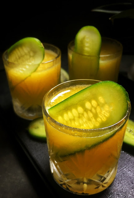 "A refreshing pineapple and cucumber detox drink in a glass."