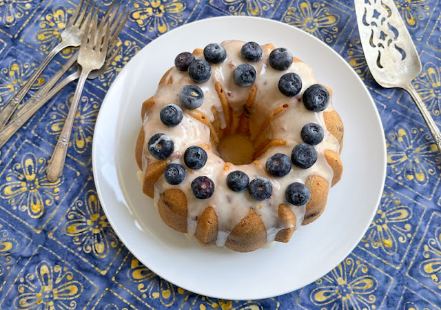 Food Lust People Love: This peach blueberry pound cake batter is made with pureed peach, and blueberries folded through, before baking to a rich, buttery finish. Top it with peach puree glaze and more blueberries for a wonderful seasonal dessert everyone will love.