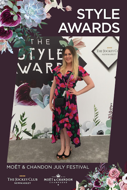 Woman standing in front of a floral backdrop which says The Style Awards