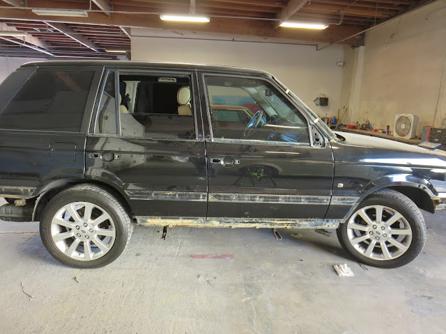 Range Rover with scratches & caked in mud from off road adventures.