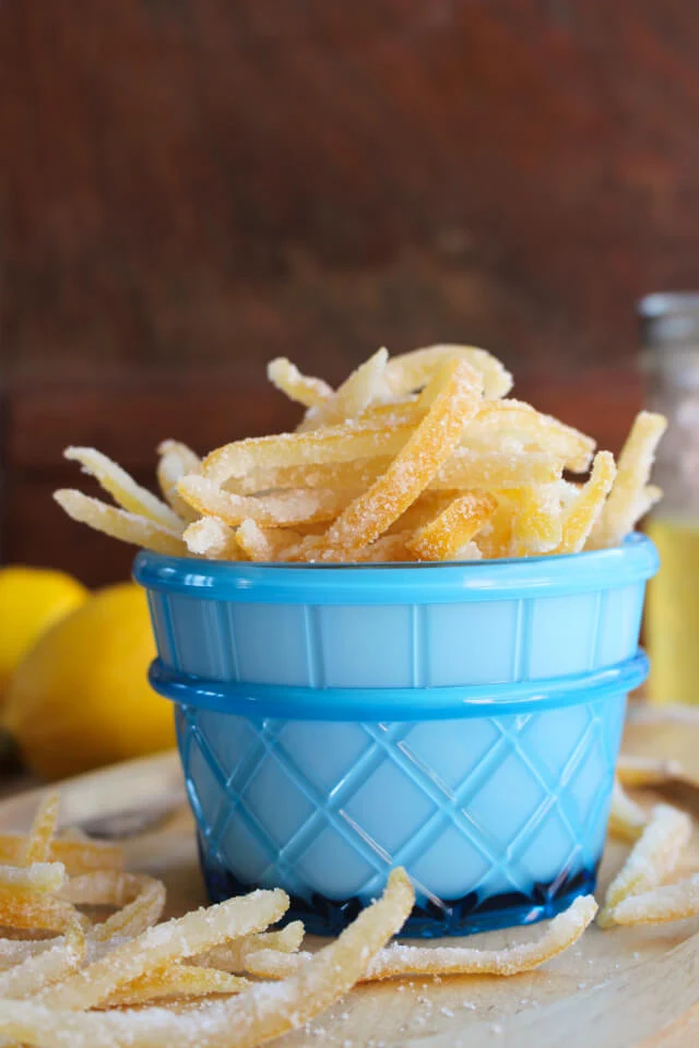 Candied Lemon Peel in a blue cup with a brown background.