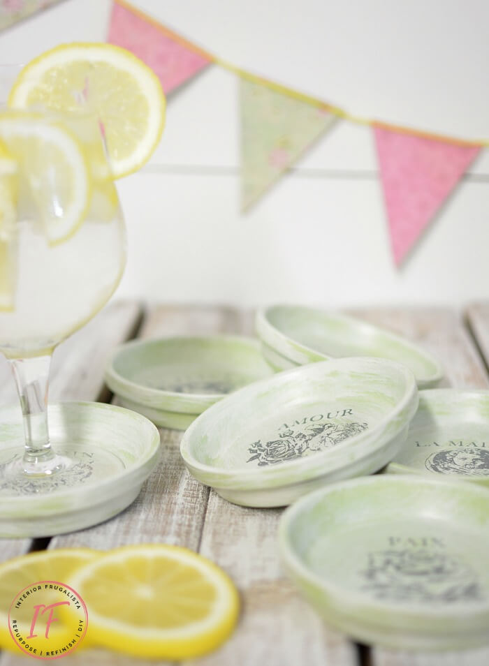 How to repurpose dollar store terracotta flower pot saucers into pretty summer drink coasters with French Country style using floral decor transfers.