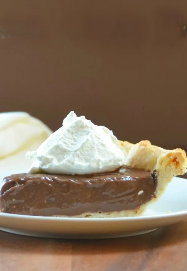 Chocolate Creamy Pie recipe is a flaky pie shell filled with creamy Chocolate Pudding from scratch. A favorite dessert recipe for Thanksgiving and Christmas from Serena Bakes Simply From Scratch.