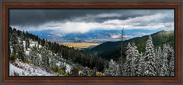 Sunlight breaks through the clouds over the city of Jackson Wyoming, as seen from Teton Pass