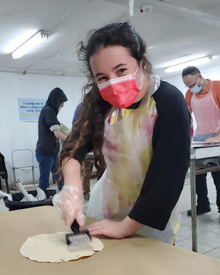 Flattening the matzah (Credit: Yishai Fleisher)