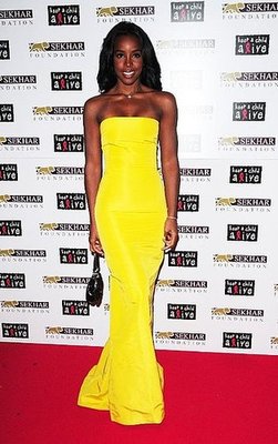 Kelly Rowland wear bright yellow maxi dress.