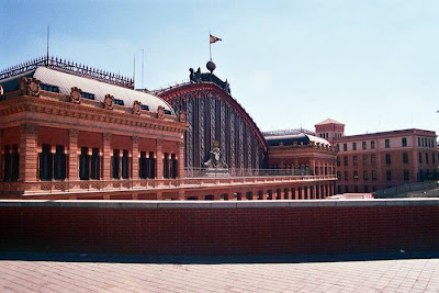 Madrid Atocha (Spanish: Estación de Madrid Atocha, also named Madrid Puerta de Atocha) is the largest railway station in Madrid. It is the primary station serving commuter trains (Cercanías), intercity and regional trains from the south, and the AVE high speed trains from Barcelona (Catalonia), Saragosse (Aragon), Seville (Andalusia) and Valencia (Levante Region). These train services are run by the Spanish national rail company, Renfe. The station is in the Atocha neighborhood of the district of Arganzuela. The original façade faces the Plaza del Emperador Carlos V, a site at which a variety of streets converge, including the Calle de Atocha, Paseo del Prado, Paseo de la Infanta Isabel, Avenida de la Ciudad de Barcelona, Calle de Méndez Álvaro, Paseo de las Delicias, Paseo de Santa María de la Cabeza, and Ronda de Atocha.