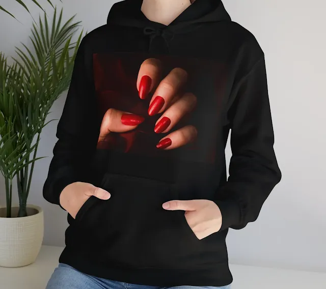 A Women Hoodie With Female Hand With Red Nails is Holding Dark Red Fabric