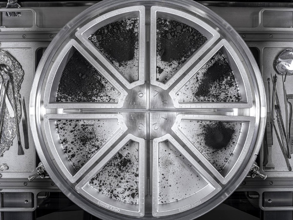 An overhead view of eight trays containing the final rock samples that were collected by NASA's OSIRIS-REx spacecraft at asteroid Bennu in late 2020.