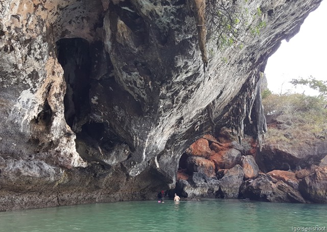 Exploring the sea caves of Phra Nang Beach at low tide.