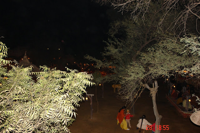 Photo of View of children playing on the swing with their moms helping them inside the tourist village of Chokhi Dhani