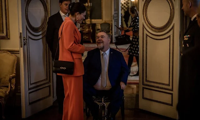 Crown Princess Victoria in Zara shawl lapel orange blazer suit. Princess Sofia in Tiger of Sweden Nicee blazer and Irez trouser