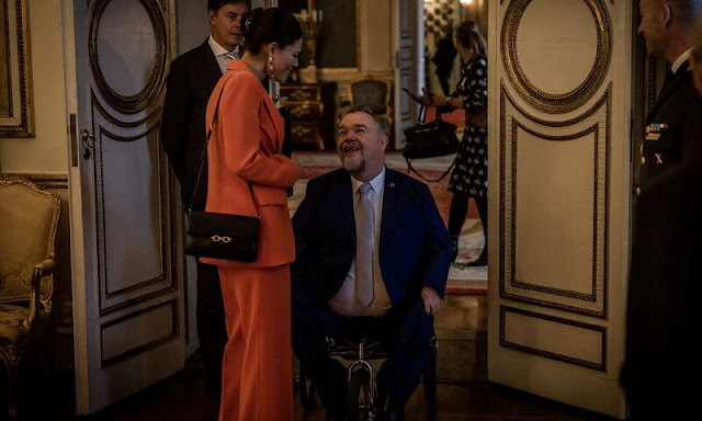 Crown Princess Victoria in Zara shawl lapel orange blazer suit. Princess Sofia in Tiger of Sweden Nicee blazer and Irez trouser