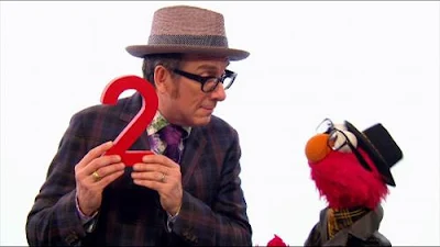 Sesame Street Episode 4267. Elvis Costello and Elmo sings a song. The name of the song is A Monster Went and Ate My Red Two.