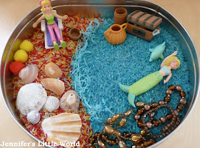 A beach and underwater themed sensory tub for children