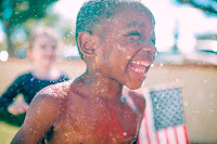 boy-water-splashes-in-his-body-smiling-for-a-close-u