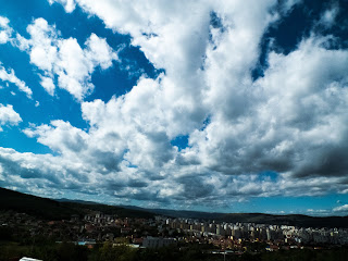 Some clouds over Manastur district in Cluj-Napoca city, the city being a bit underexposed for a dramatic effect