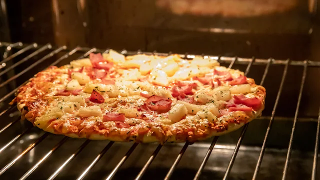 How do I cook a frozen pizza on a pizza stone in the oven?