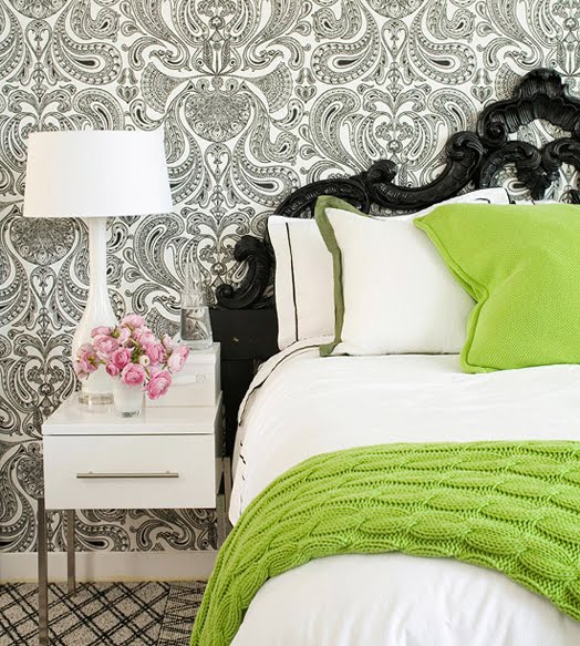 Black and white wallpaper with a black headboard and white nightstand