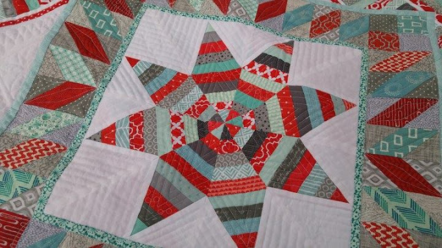 Red and aqua string star round robin quilt