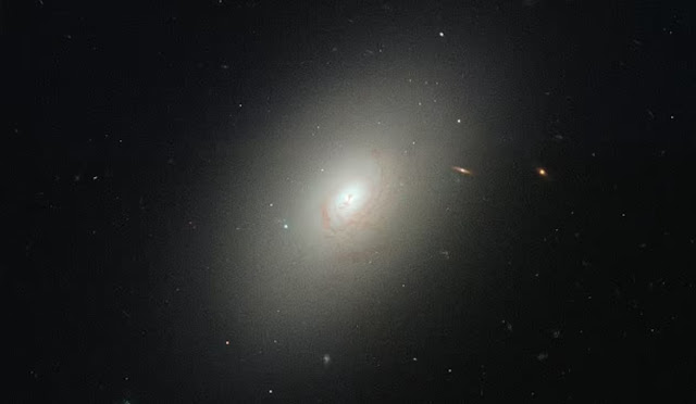 The scientists observed ancient and dormant galaxies and found that black holes gain mass in a way that is consistent with them containing vacuum energy, or Dark Energy. Pictured is NGC 4150, an elliptical galaxy 45 million light years away in the constellation Coma Berenices