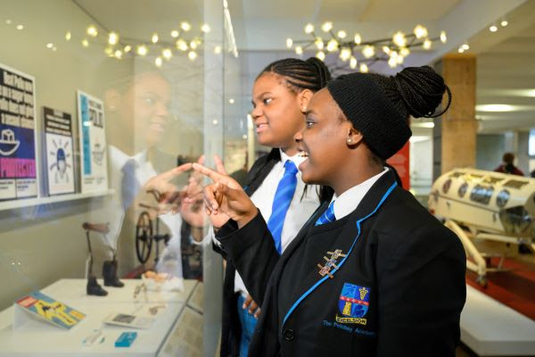 Two students pointing at museum exhibits