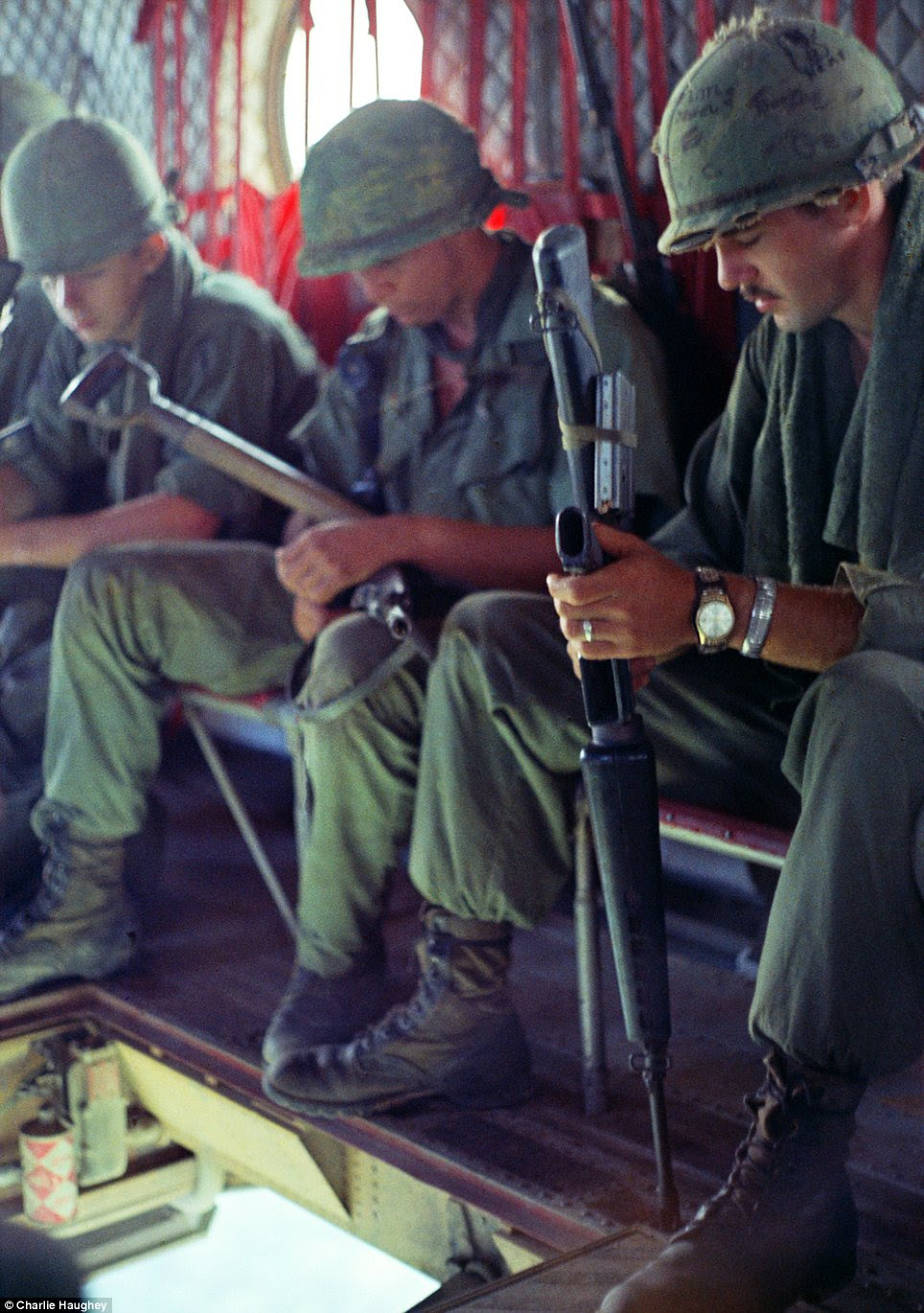Time out: Soldiers enjoy a brief moment of relaxation as they ride a Chinook over Vietnam