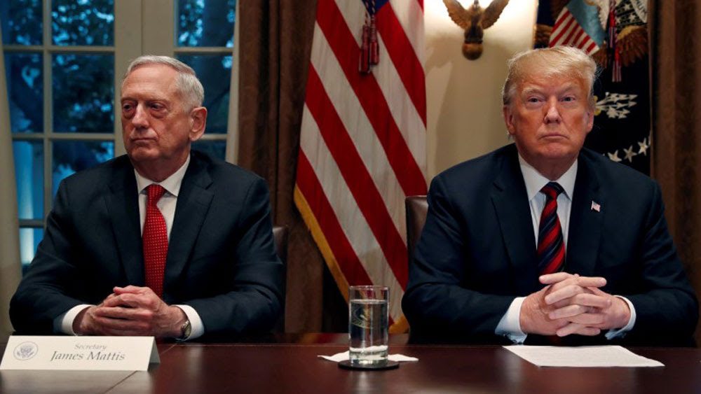 US President Donald Trump speaks to the news media while gathering for a briefing from his senior military leaders, including former Defense Secretary James Mattis (L), at the White House, October 23, 2018.