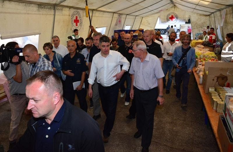 Croatian Prime Minister Zoran Milanoviuc inspects a refugee food and first aid tent