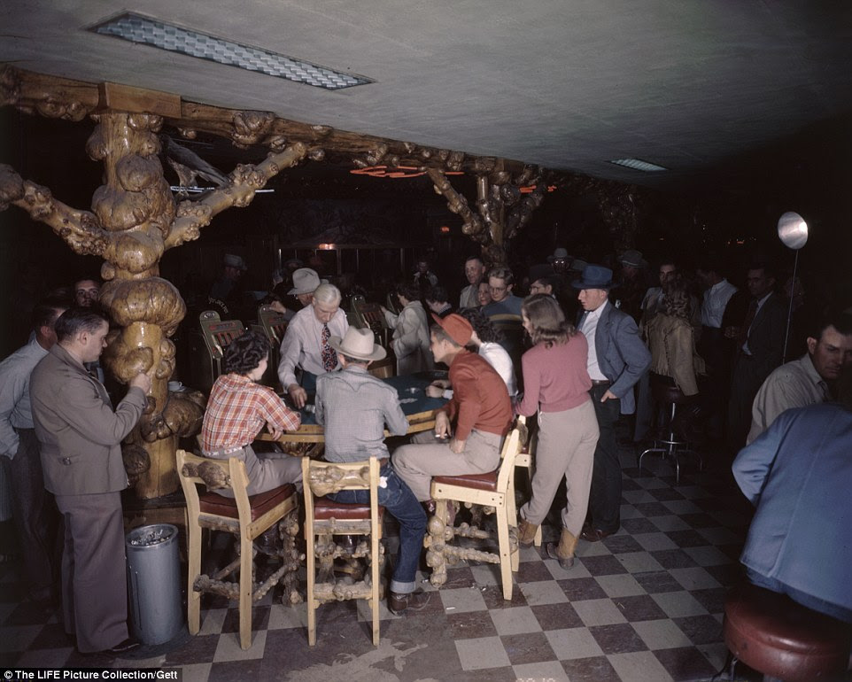 Howdy boys: A room full of patrons gambling at The Cowboy Bar in Jackson Hole in Wyoming, after flocking from the city for a break