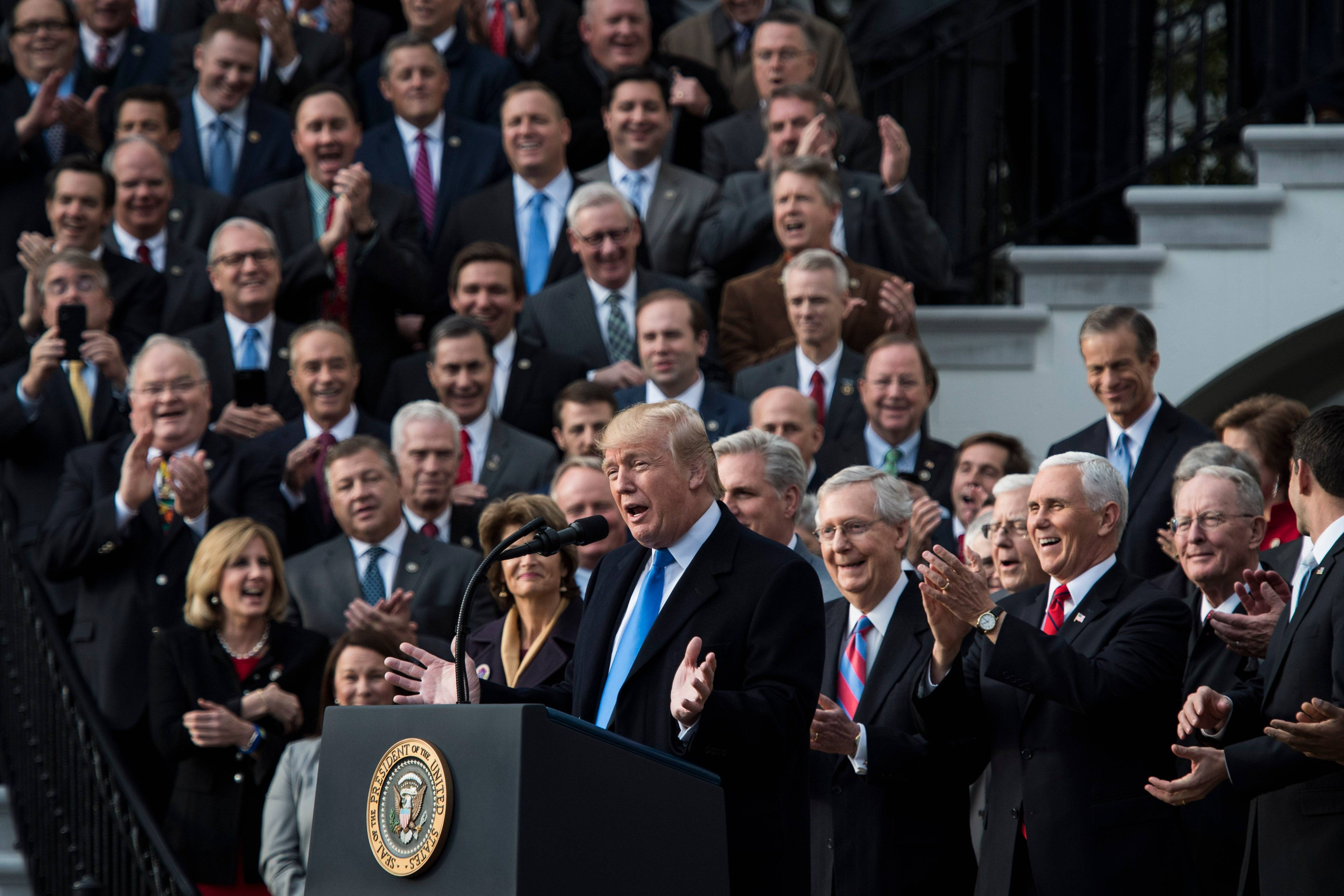 President Trump celebrates the passage of the tax bill with congressional Republicans in December 2017. His lawyers now say everyone who voted for this bill did so intending to get rid of the Affordable Care Act. (Jabin Botsford/The Washington Post)