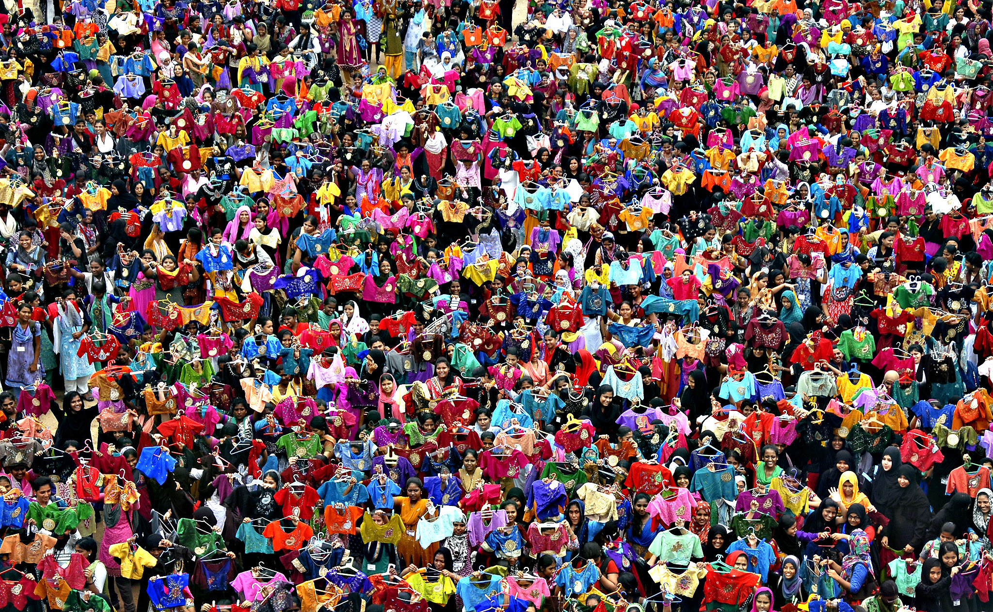 Students display the painted liquid embroidery blouses inside their college premises in Chennai, India, on Friday. 3,500 students painted 7000 blouses in an hour on Friday in an attempt to enter the Limca Book of Records