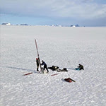 image of people collecting underground water data from a snow-covered surface