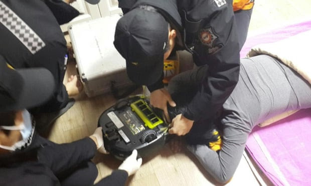  Firefighters try to rescue a woman at her house in Changwon, southeast South Korea after her hair was sucked into a robot vacuum cleaner. She lost about 10 strands of hair but was not injured. Photograph: Yonhap/AAPIMAGE