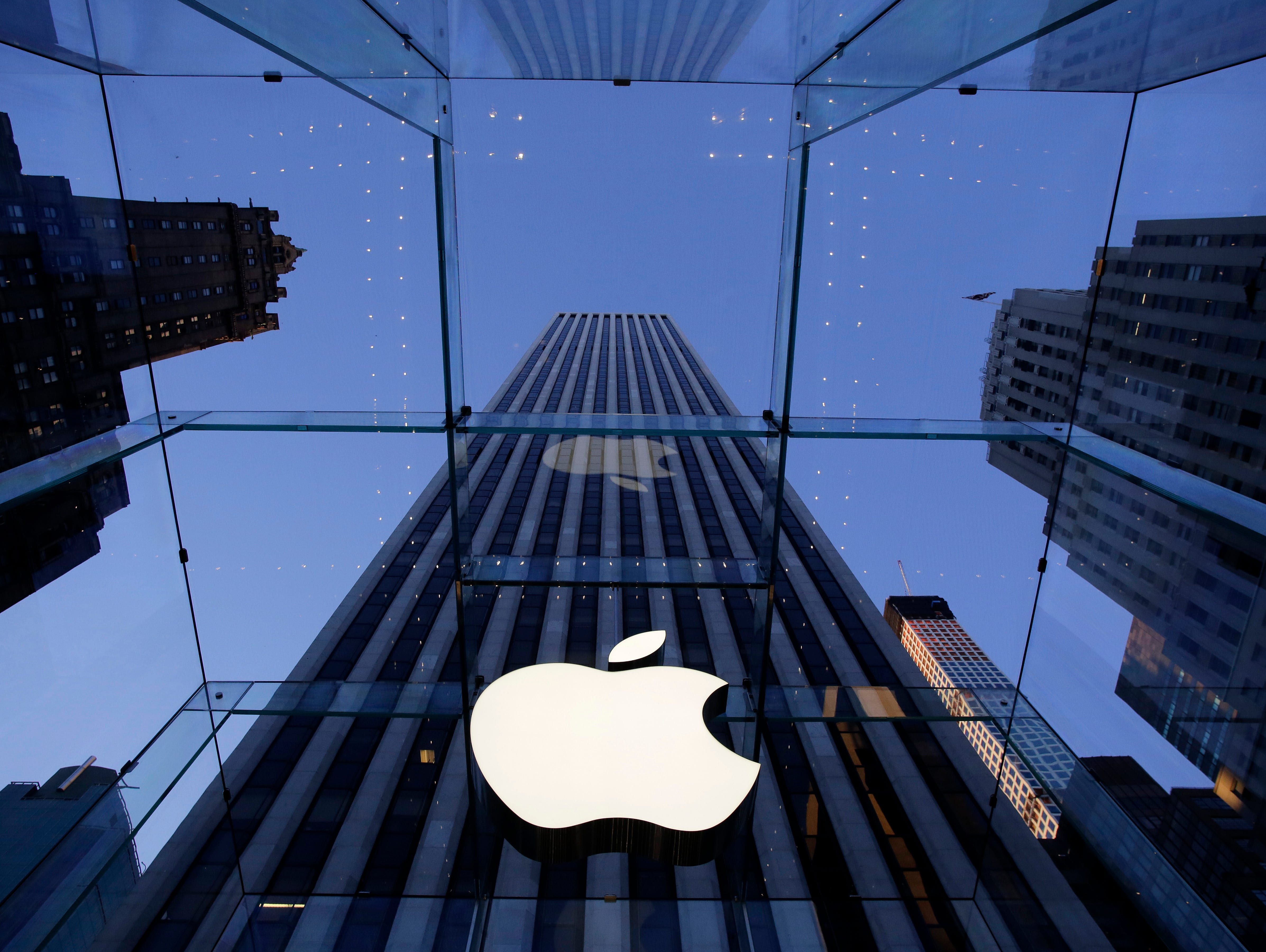 The Apple logo hangs in the glass box entrance to the company's Fifth Avenue store in New York.