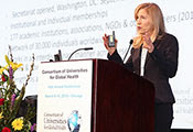 Dr. Ann Kurth speaks at a podium at the CUGH 2019 annual meeting.