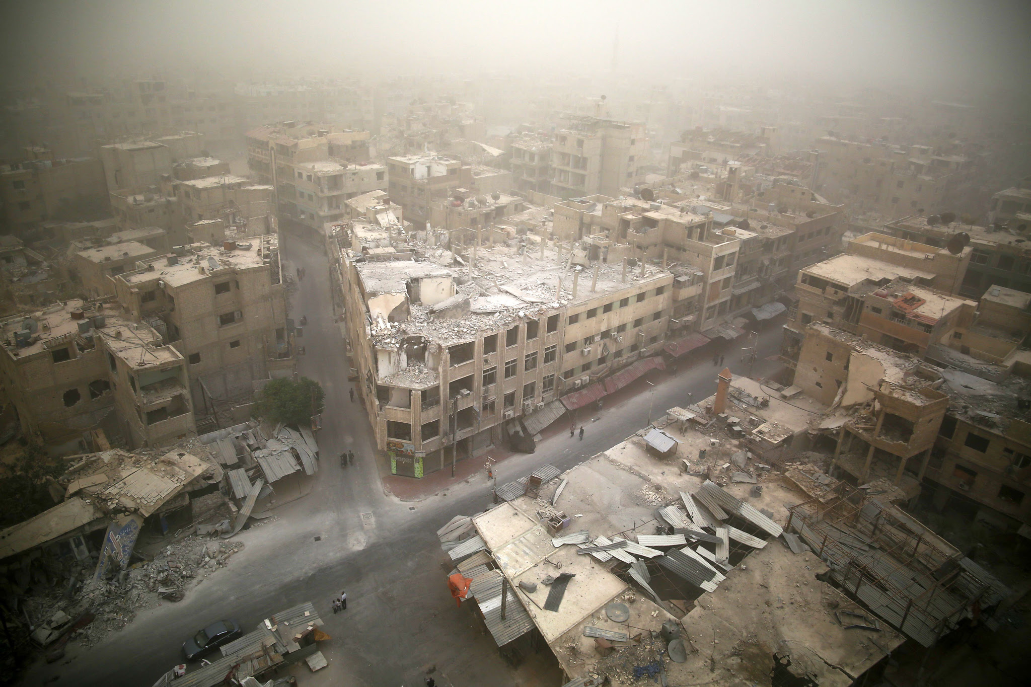 TOPSHOTS A picture taken on September 7,...TOPSHOTS A picture taken
 on September 7, 2015 shows a general view of damaged buildings in the 
rebel-held area of Douma, east of the capital Damascus as a sandstorm 
blows over the city.  AFP PHOTO / SAMEER AL-DOUMY  SAMEER 
AL-DOUMY/AFP/Getty Images