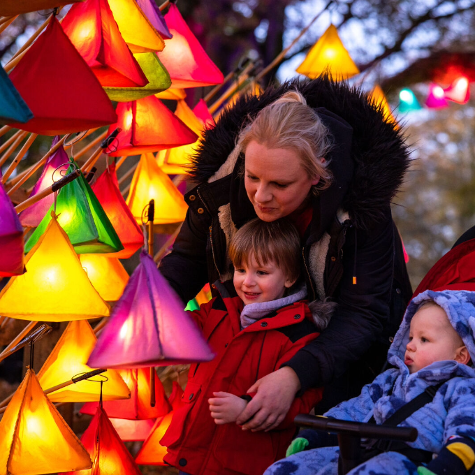 A family with lanterns at Glow Wild