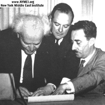 Ben Gurion is signing a small piece of scroll