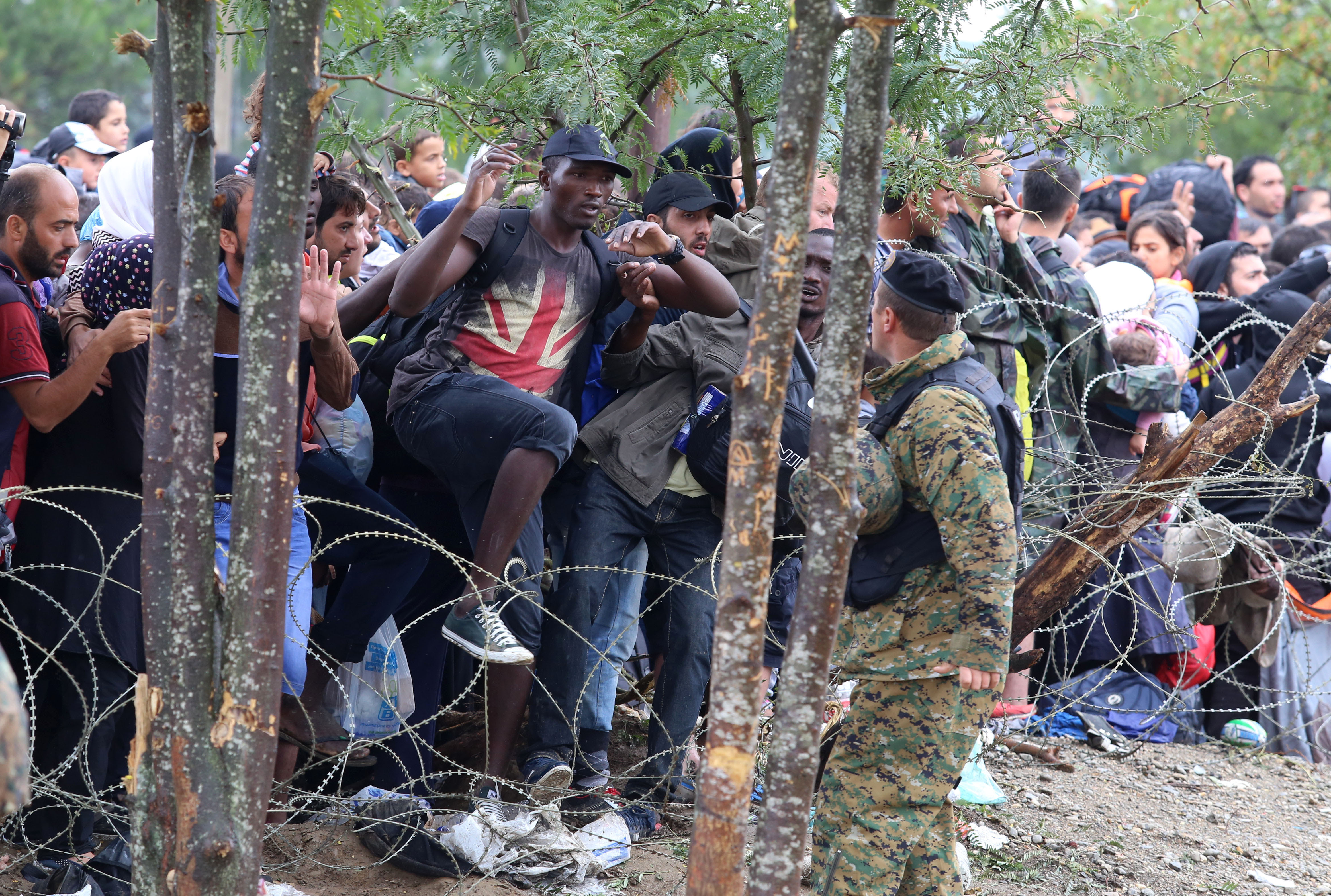 Migrants break the police blockade to enter into Macedonia from Greece late 2015 (AP Photo/Vlatko Perkovski)