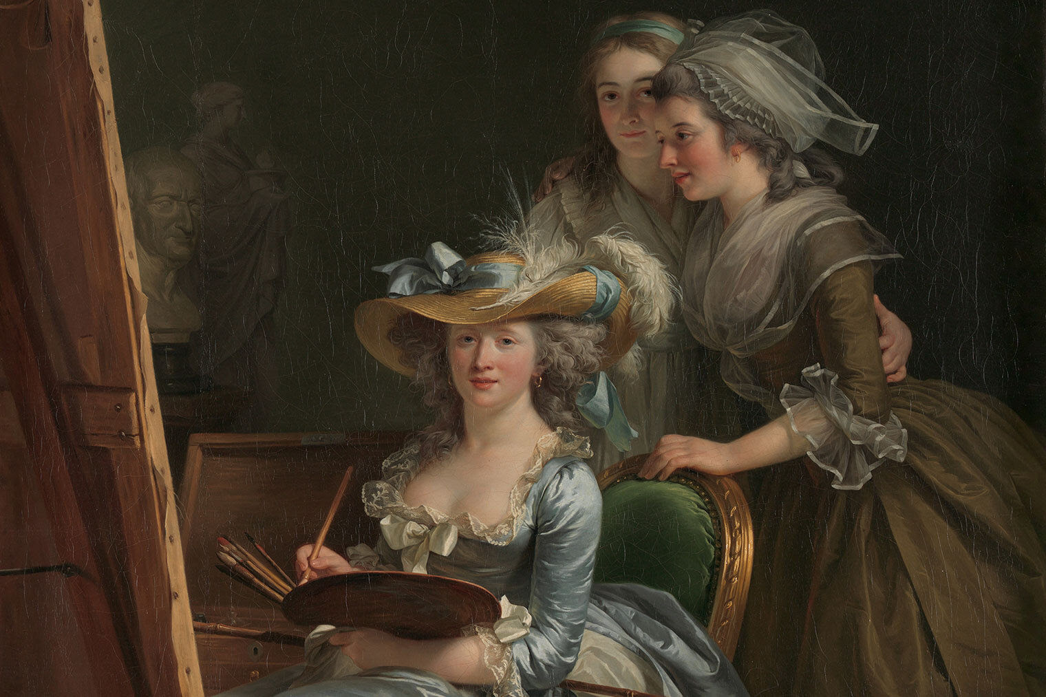 Uma pintura de três mulheres em um estúdio