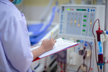 Nurse checking a dialysis machine