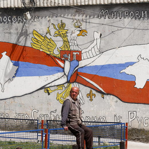 epa09272718 A man sits near a graffiti depicting Serbia's national flag with a map of Kosovo in the northern Serb dominated part of the ethnically divided town of Mitrovica, in Mitrovica, Kosovo, 15 June 2021. Political leaders of Kosovo and Serbia will resume EU-mediated talks in Brussels on 15 June, aimed at normalizing their relations. EPA/VALDRIN XHEMAJ