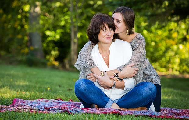 An adult daughter hugging her mother.